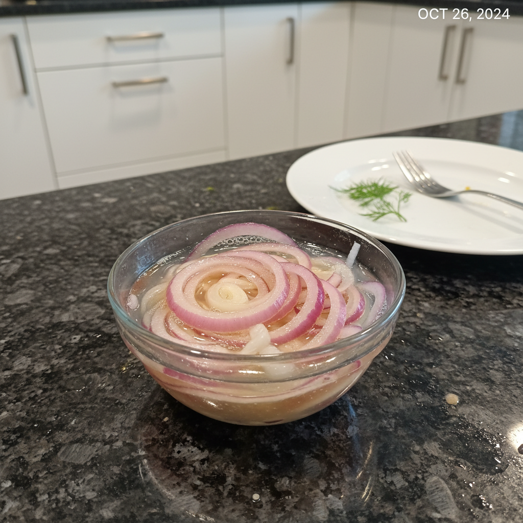 A close-up of vibrant pink fermented onions in a glass jar, ready to eat, with a fresh herb garnish.